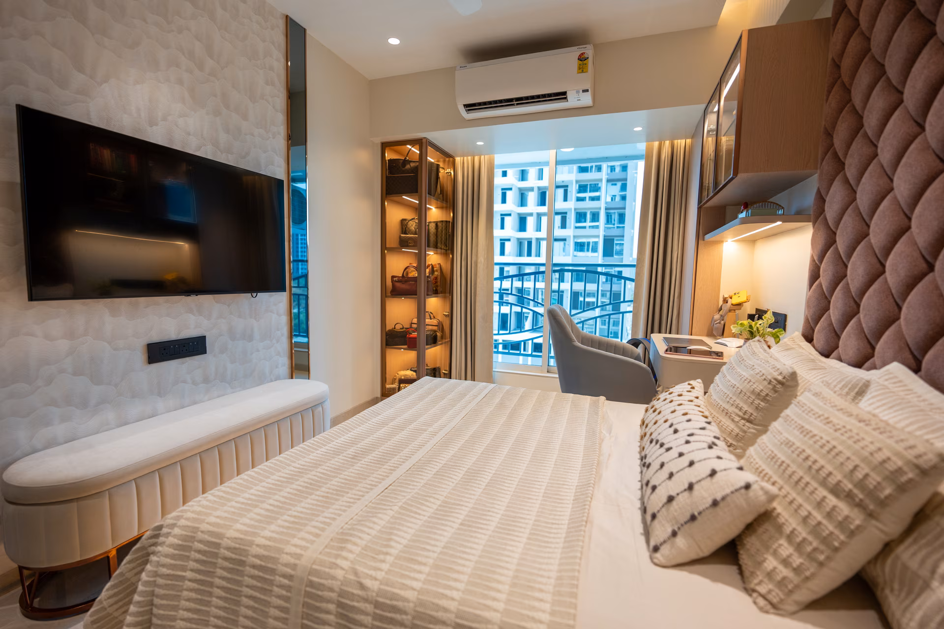 Elegant 2 BHK bedroom with TV unit, balcony access and work seating designed by ASK Design and Build