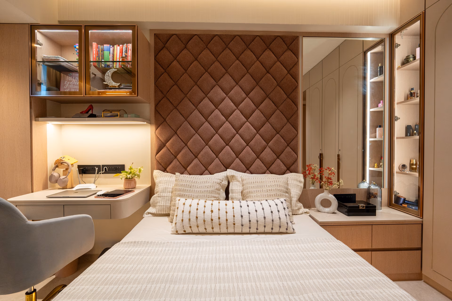 Compact bedroom with integrated study desk, wardrobes and display shelving by ASK Design and Build