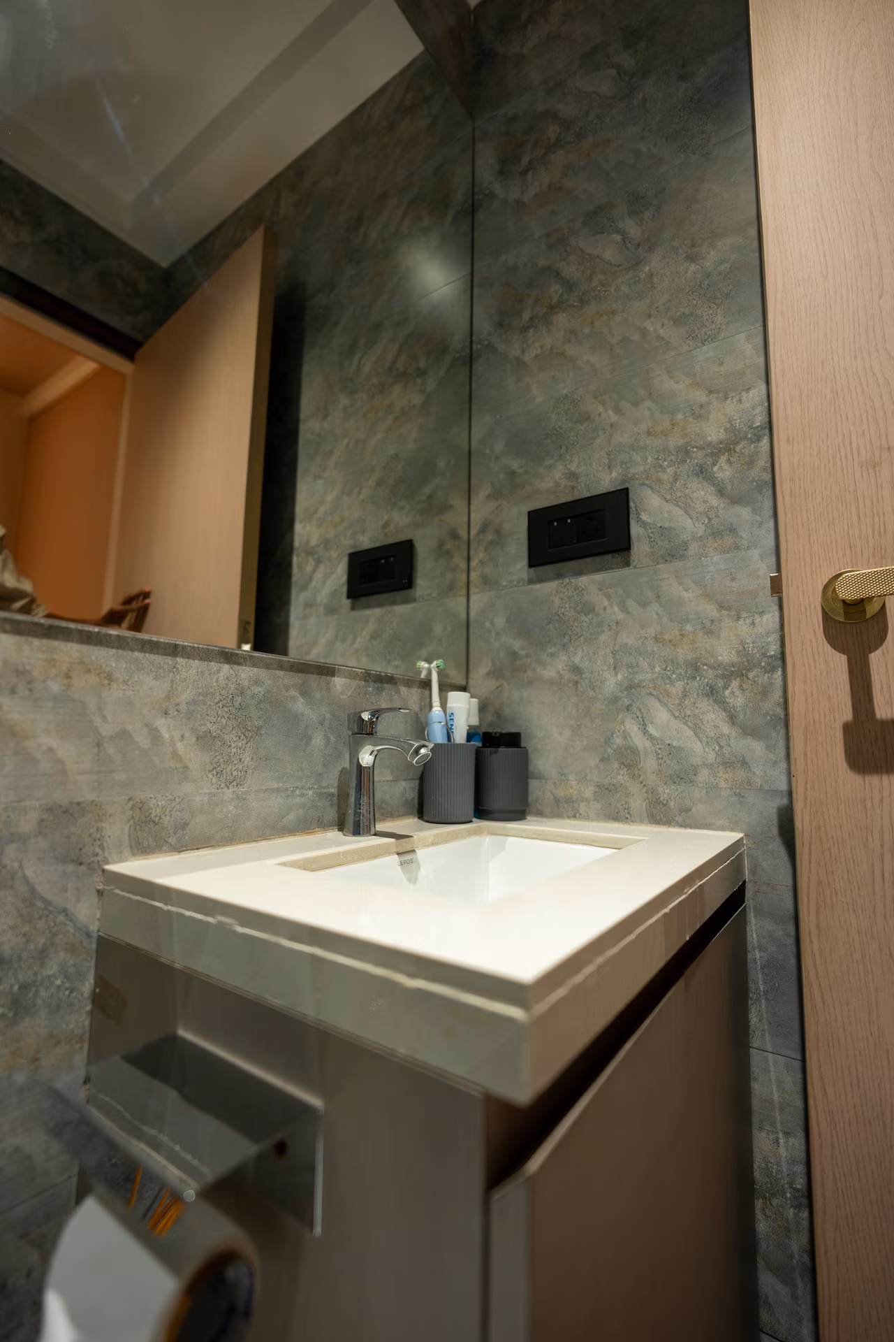 Bathroom vanity with durable stone-finish tiles and quartz countertop by ASK Design and Build