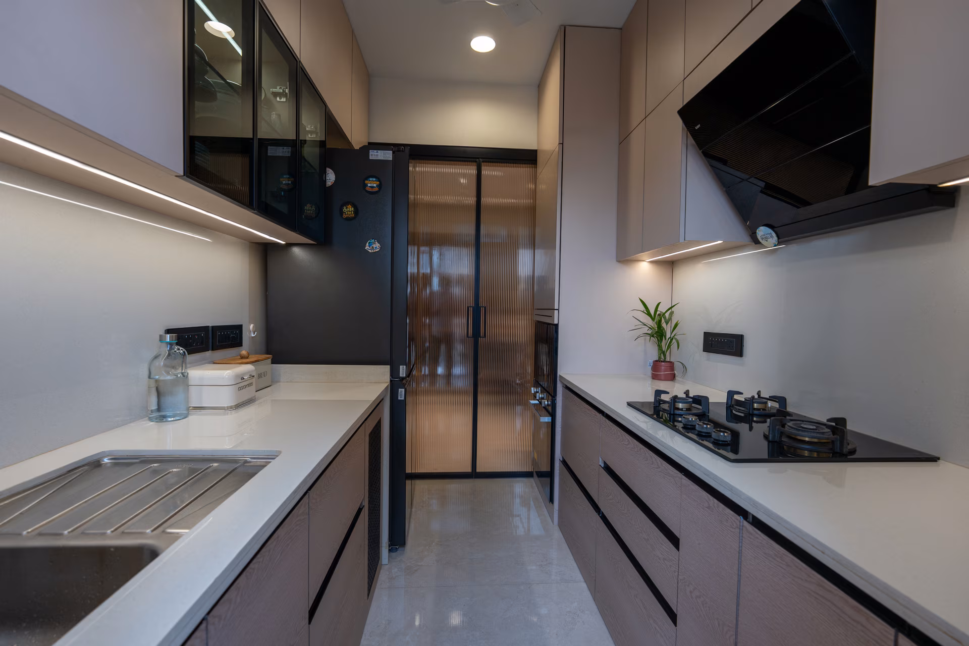 Modular parallel kitchen with sleek cabinetry and built-in hob designed by ASK Design and Build