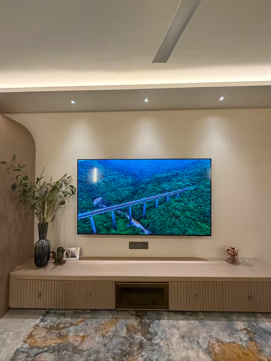 Living room TV wall with a floating console, fluted panelling and cove lighting by ASK Design and Build