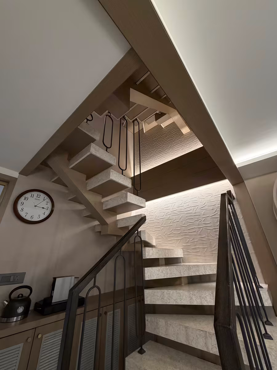 Open-tread staircase with a slim metal railing in a Vashi row house by ASK Design and Build