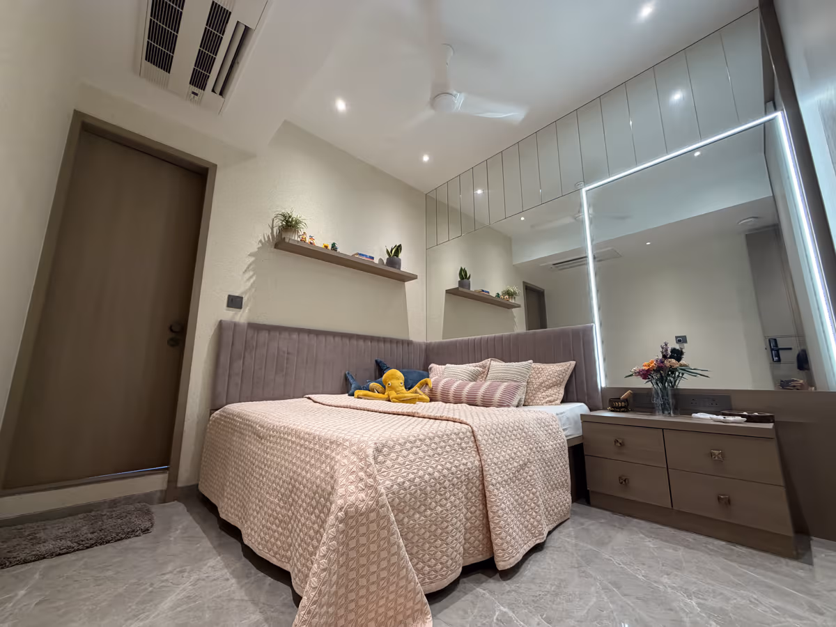 Personalised bedroom design with mirrored panels and soft furnishings by ASK Design and Build