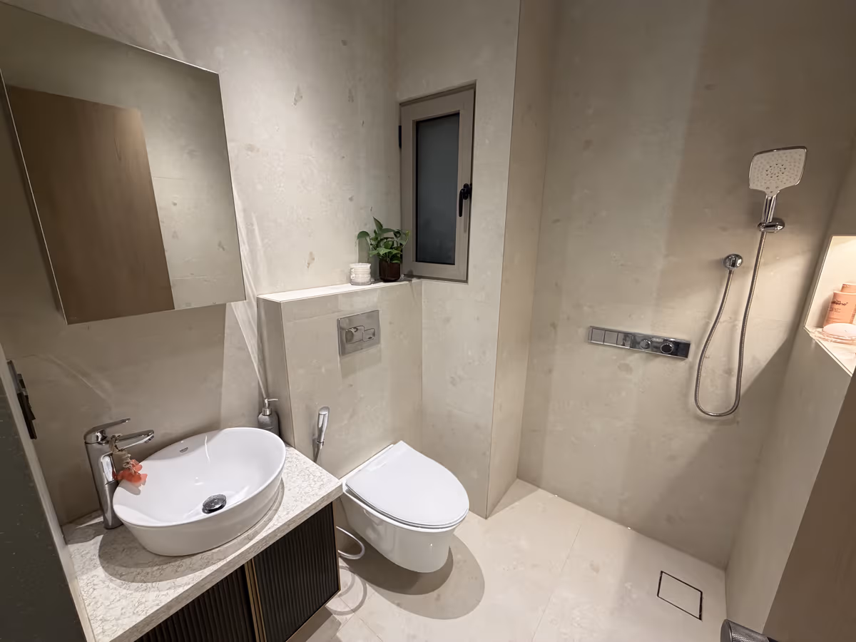 Bathroom finished in durable, easy-to-maintain stone-look surfaces by ASK Design and Build