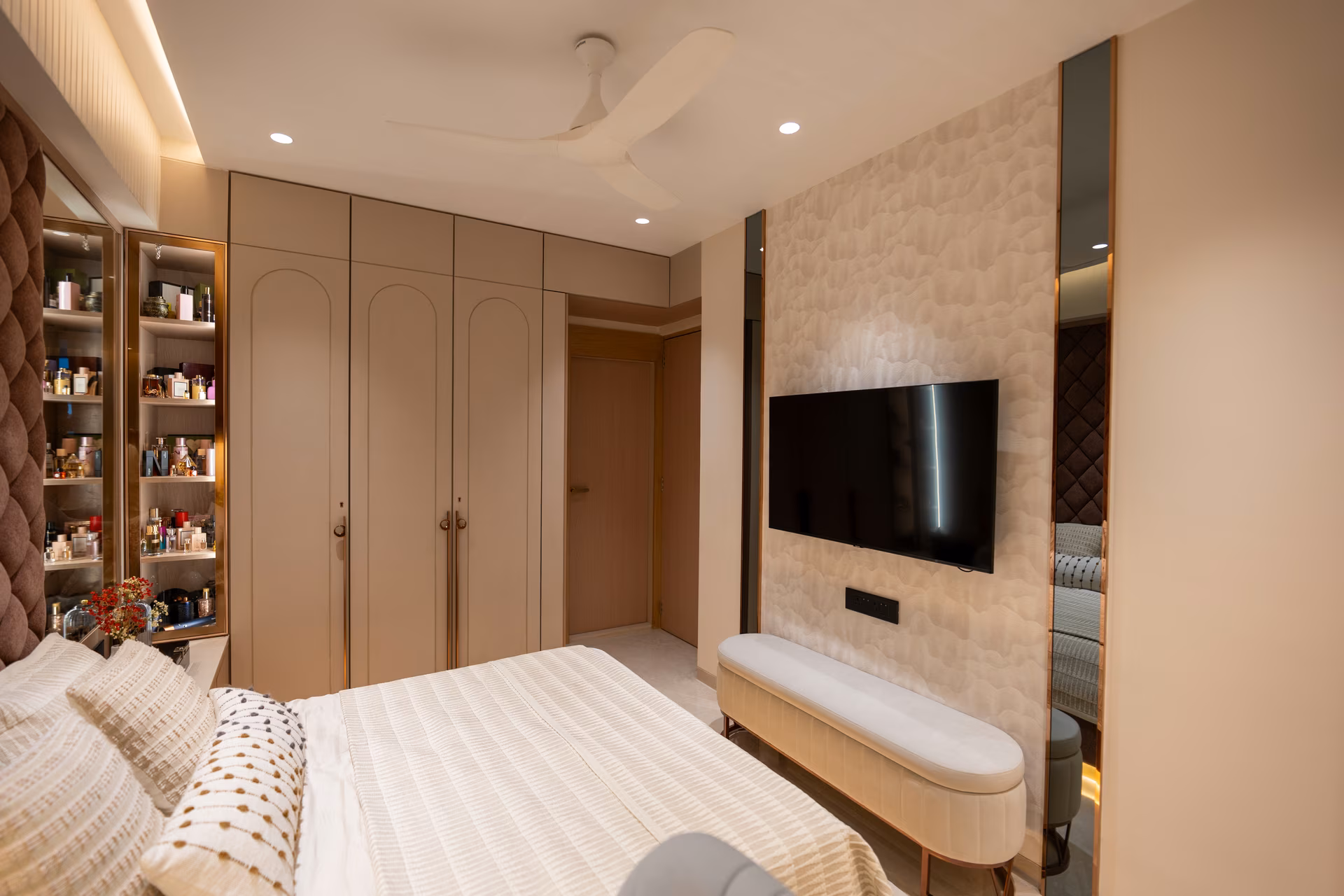 Bedroom with floor-to-ceiling wardrobes and wall-mounted TV unit designed by ASK Design and Build
