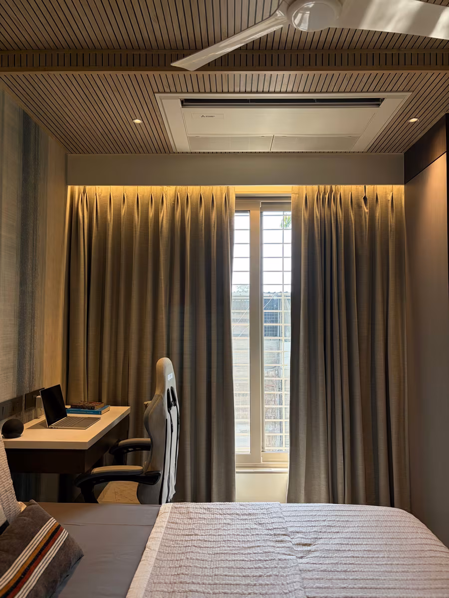 Compact bedroom with a built-in study desk, wall panelling and a coffered ceiling by ASK Design and Build