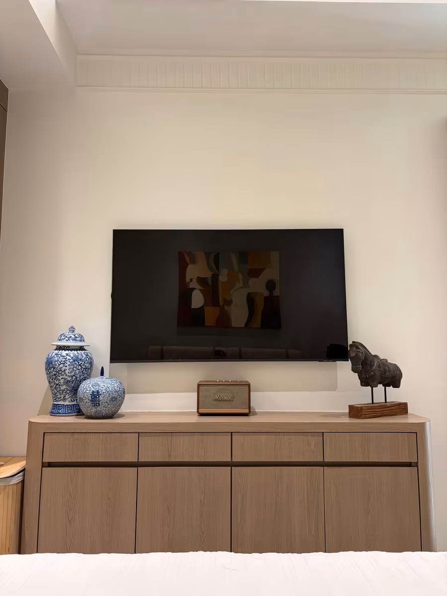 Low modular sideboard with closed storage doubling as a TV console by ASK Design and Build