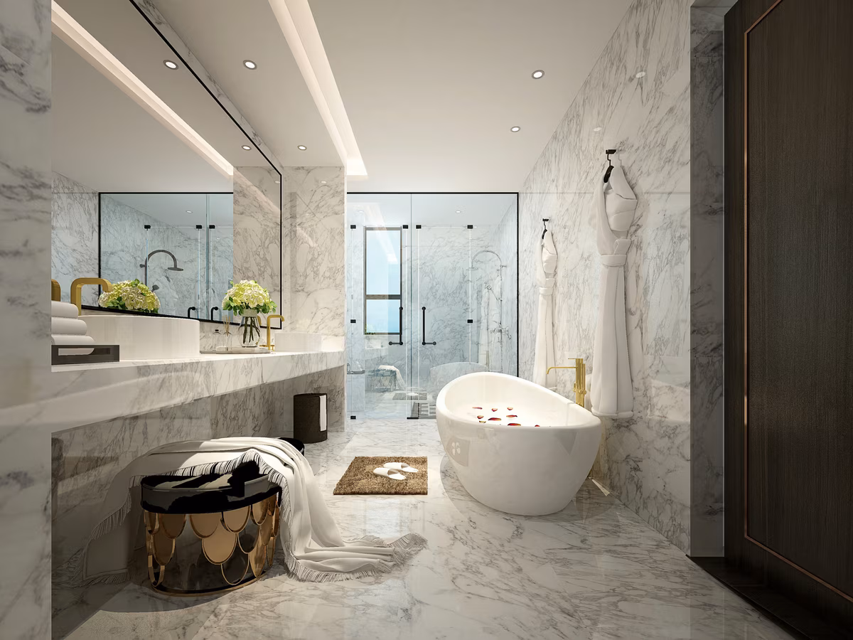 Luxury marble bathroom featuring freestanding tub, floating vanity, and designer ottoman