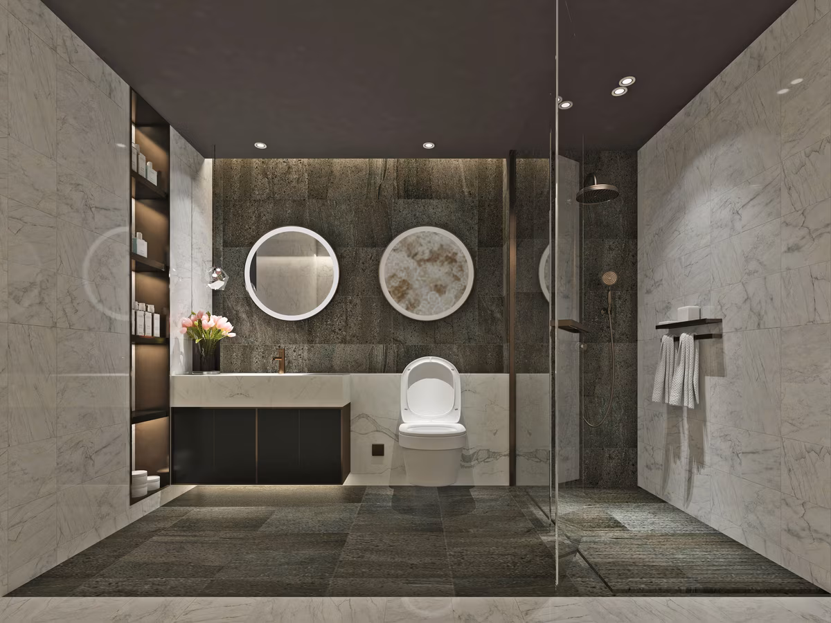 Modern bathroom with contrasting dark and light surfaces, circular mirrors, and built-in illuminated storage