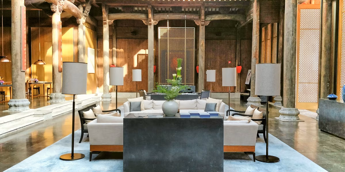 Traditional Asian lounge with wooden seating, traditional decor, and soft lighting