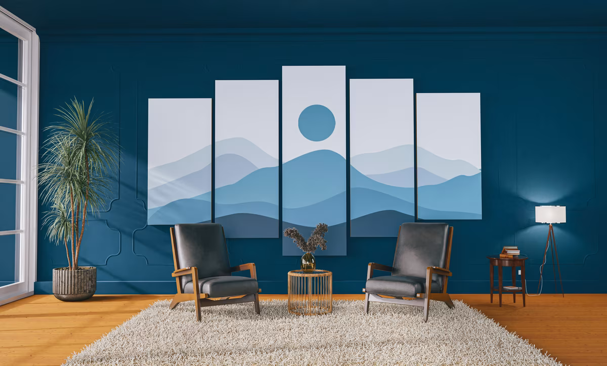 Minimalist living room with teal walls and mountain artwork installation