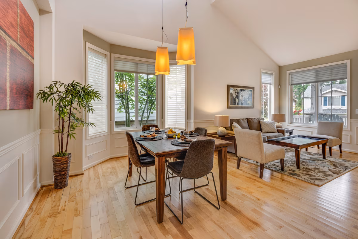 Transitional living-dining room with wainscoting and warm wood floors