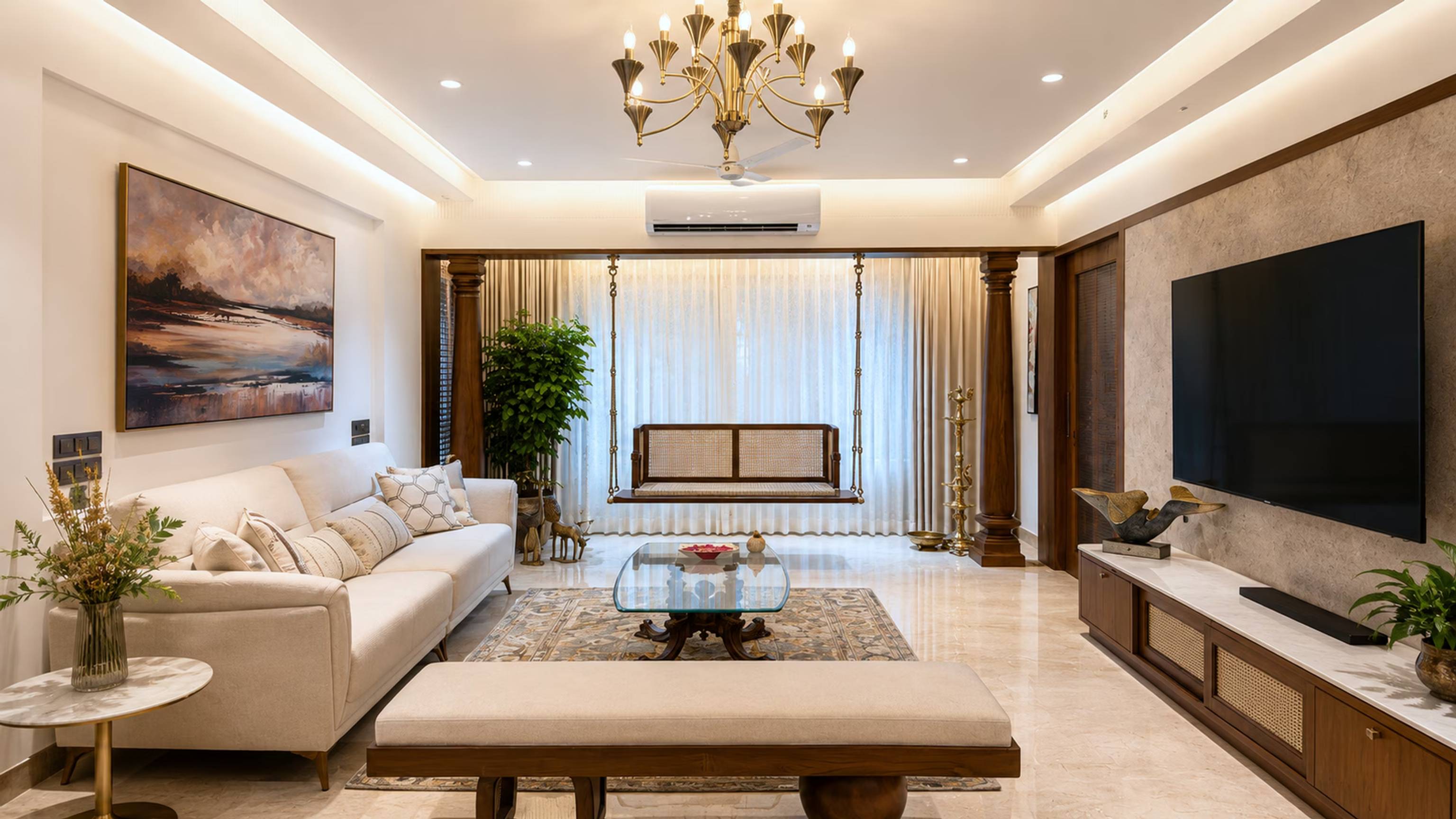 Elegant living room with chandelier and classic swing designed by ASK Design and Build, Mumbai