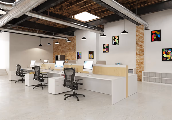 Creative open office with collaborative desks, vibrant decor, and industrial elements