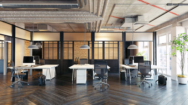Industrial chic office with exposed brick walls, modern workstations, and pendant lights