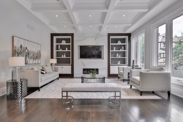 Luxury living room with coffered ceiling and custom built-in shelving